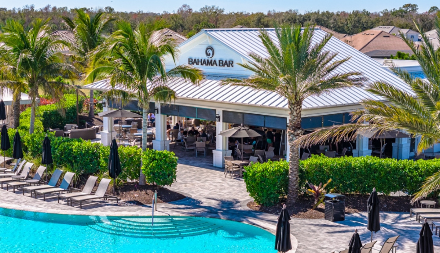 The Bahama Bar at Esplanade, an open-air pavilion beside the resort pool at golden hour